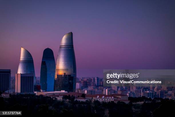 flame towers in baku at dusk. - baku stock pictures, royalty-free photos & images