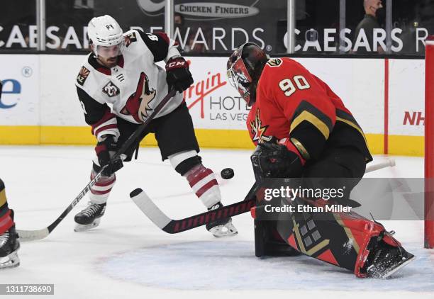 Robin Lehner of the Vegas Golden Knights defends the net against Conor Garland of the Arizona Coyotes in the first period of their game at T-Mobile...