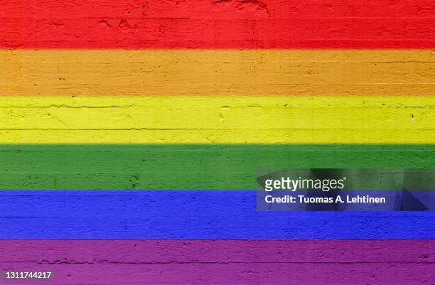 rainbow colored lgbt pride flag painted on a concrete wall. - rainbow flag stock pictures, royalty-free photos & images