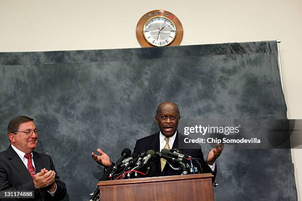 Republican presidential candidate and former CEO of Godfather's Pizza Herman Cain asks "Are you all too busy to clap?" while participating in a...