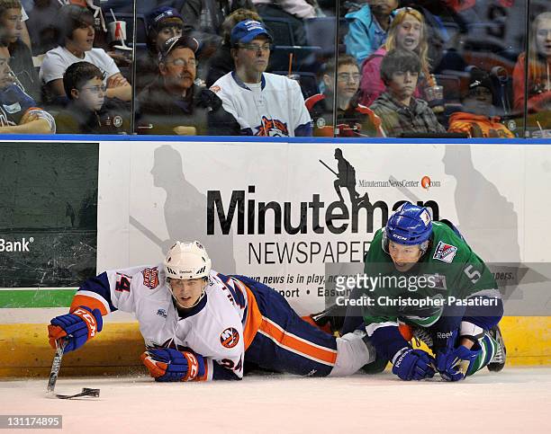 Blake Parlett of the Connecticut Whale and David Ullstrom of the Bridgeport Sound Tigers play for possession of the puck during the first period at...