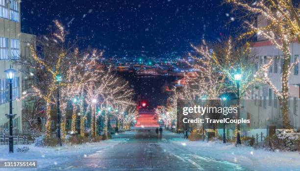 hakodate, hokkaido, japan on hachiman-zaka slope with holiday lighting at night. - christmas scene stock pictures, royalty-free photos & images