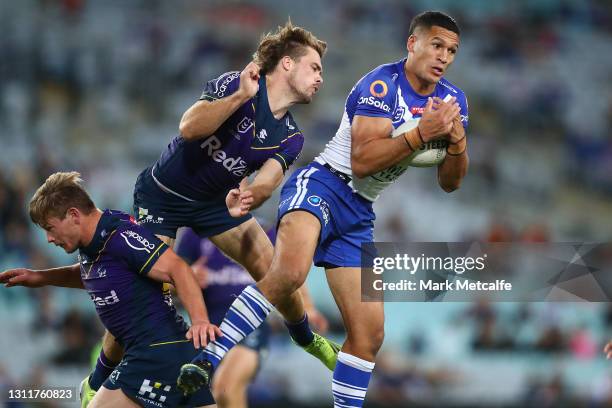 Dallin Watene-Zelezniak of the Bulldogs beats Ryan Papenhuyzen of the Storm in the air during the round five NRL match between the Canterbury...