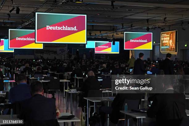 Delegates of the right-wing Alternative for Germany political party watch the presentation of an election campaign video at the AfD federal party...