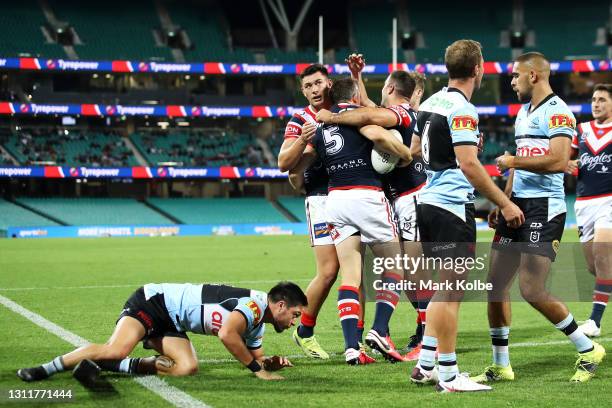 Brett Morris of the Roosters celebrates with his team mates after scoring a try during the round five NRL match between the Sydney Roosters and the...