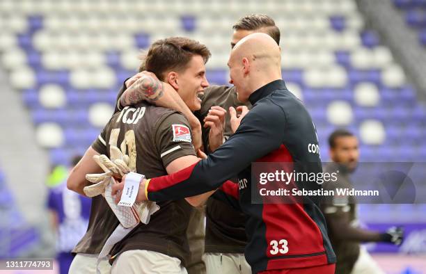 Luca Zander of St Pauli celebrates with Svend Brodersen and teammates after scoring their team's first goal during the Second Bundesliga match...