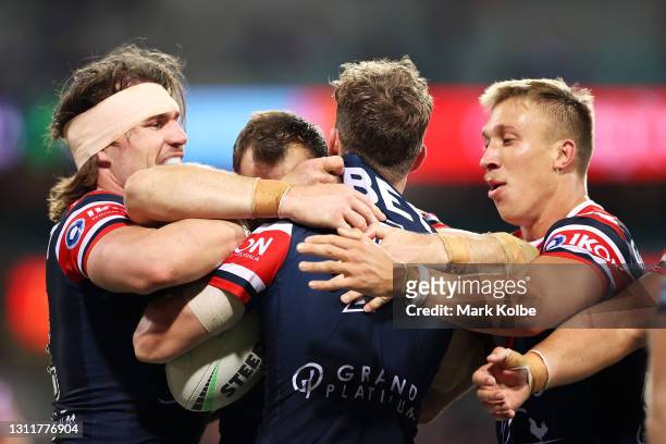Sam Walker of the Roosters celebrates with his team mates after scoring a try during the round five NRL match between the Sydney Roosters and the...