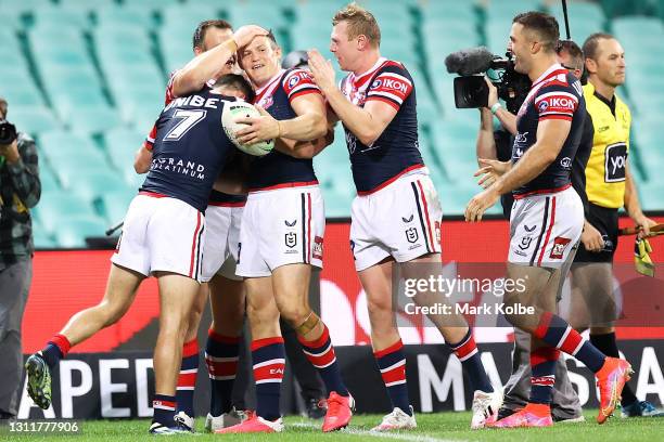 Brett Morris of the Roosters celebrates with his team mates after scoring a try during the round five NRL match between the Sydney Roosters and the...