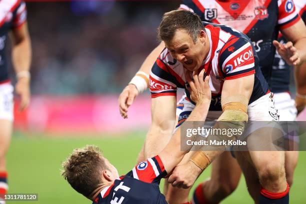 Sam Walker of the Roosters celebrates with his team mate Josh Morris after scoring a try during the round five NRL match between the Sydney Roosters...