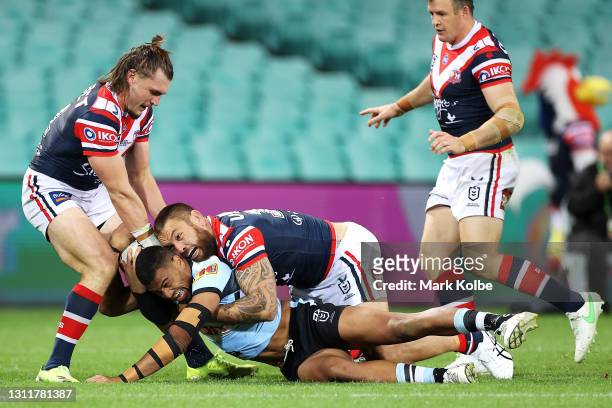 Ronaldo Mulitalo of the Sharks is tackled into touch by Angus Crichton and Jared Waerea-Hargreaves of the Roosters during the round five NRL match...