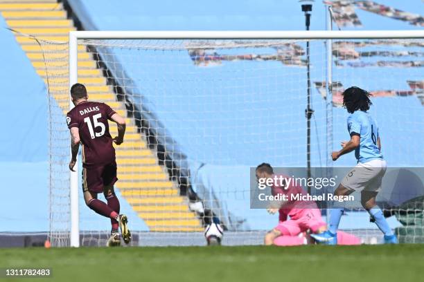 Stuart Dallas of Leeds United scores their team's first goal past Ederson of Manchester City during the Premier League match between Manchester City...