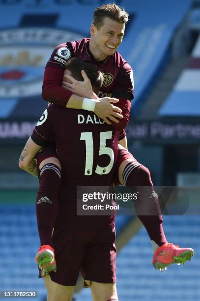 Stuart Dallas of Leeds United celebrates with Ezgjan Alioski after scoring their team's first goal during the Premier League match between Manchester...