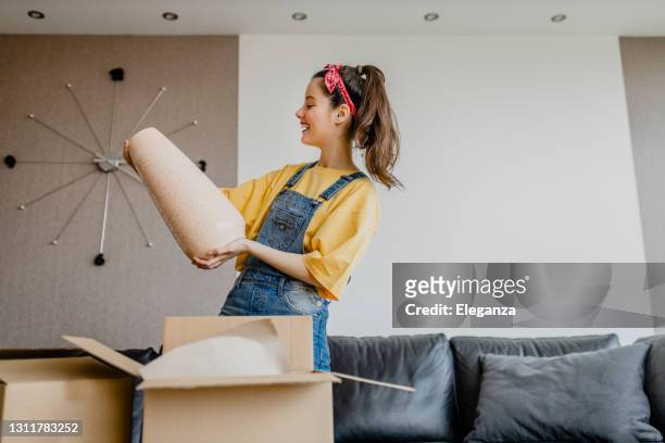 lady shopaholic customer unpacking delivery box, take out pink vase, online shopping shipment - furniture stock pictures, royalty-free photos & images