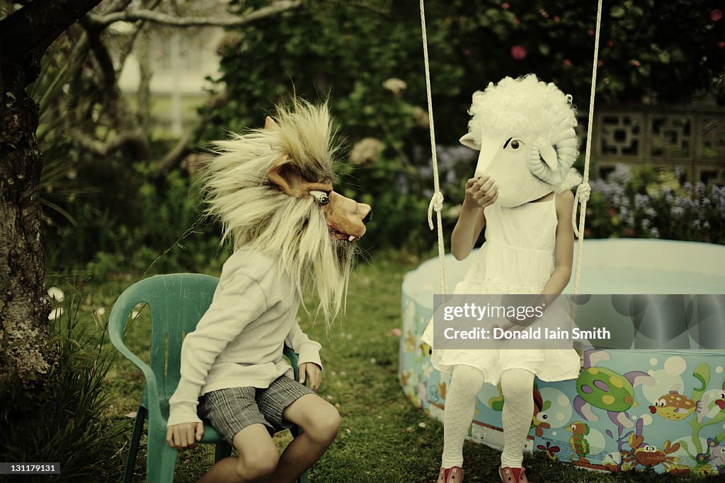 Boy and girl wearing wolf and sheep mask