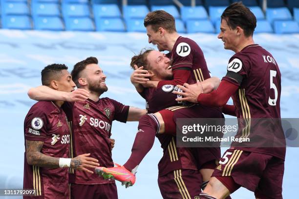 Stuart Dallas of Leeds United celebrates with teammates after scoring their team's second goal during the Premier League match between Manchester...