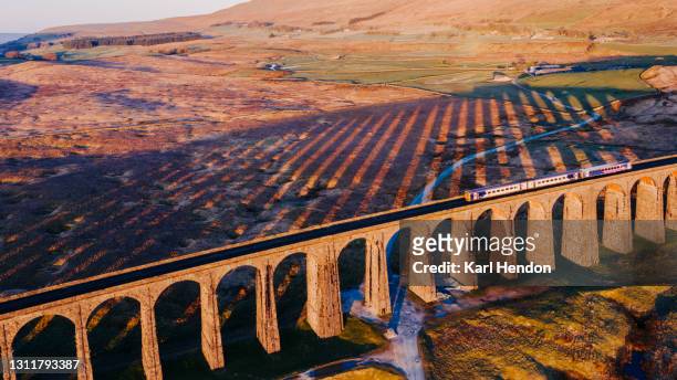 an aerial view of a train crossing ribblehead viaduct, north yorkshire - stock photo - ribblehead viaduct stock pictures, royalty-free photos & images