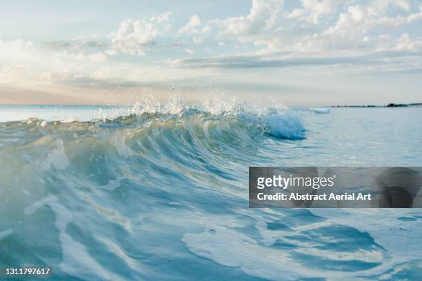 close up shot of breaking wave, broome, western australia, australia - ocean shore stock-fotos und bilder