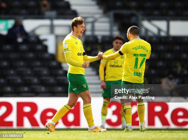 Kieran Dowell of Norwich City celebrates with Emi Buendia after scoring their team's first goal during the Sky Bet Championship match between Derby...