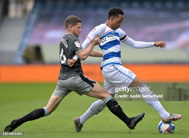 Sam Hutchinson of Sheffield Wednesday tackles Chris Willock of Queens Park Rangers during the Sky Bet Championship match between Queens Park Rangers...