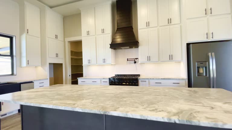 https://media.gettyimages.com/id/1311801628/video/spacious-kitchen-island-counter-toward-the-french-doors-and-retro-farm-sink-new-single-family.jpg?b=1&s=640x640&k=20&c=CgAL1slXo4wMiNr1dBdzvI37L8FTxH0blH1wUGHnpCE=