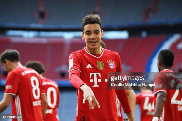 Jamal Musiala of FC Bayern Muenchen celebrates after scoring their team's first goal during the Bundesliga match between FC Bayern Muenchen and 1. FC...