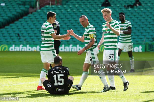 Scott Brown of Celtic celebrates with Mohamed Elyounoussi and Stephen Welsh after scoring their team's third goal during the Ladbrokes Scottish...