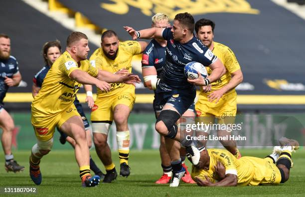 Rohan Janse van Rensburg of Sale Sharks is tackled by Pierre Bourgarit of La Rochelle during the Quarter Final Champions Cup match between La...