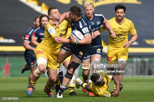 Rohan Janse van Rensburg of Sale Sharks is tackled by Pierre Bourgarit of La Rochelle during the Quarter Final Champions Cup match between La...