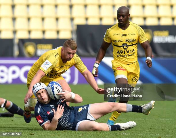 Curtis Langdon of Sale Sharks is tackled by Pierre Bourgarit of La Rochelle during the Quarter Final Champions Cup match between La Rochelle and Sale...