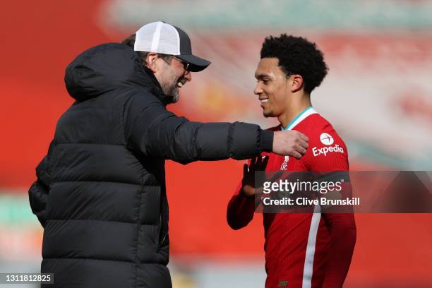 Juergen Klopp, Manager of Liverpool celebrates with Trent Alexander-Arnold of Liverpool following the Premier League match between Liverpool and...