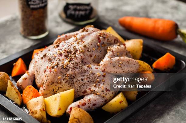 still life full length raw chicken for roasting preparation - roast chicken table stock pictures, royalty-free photos & images