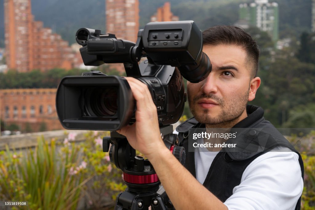 Cameraman outdoors recording breaking news