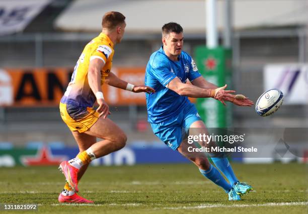 Johnny Sexton of Leinster passes the ball under pressure from Henry Slade of Exeter Chiefs during the Heineken Champions Cup Quarter Final match...