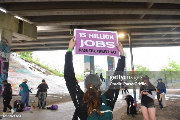 Supporter holds a sign at the Recovery Recess event to call for economic recovery and infrastructure package prioritizing climate, care, jobs, and...