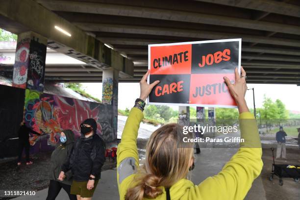 Supporter holds a sign at the Recovery Recess event to call for economic recovery and infrastructure package prioritizing climate, care, jobs, and...