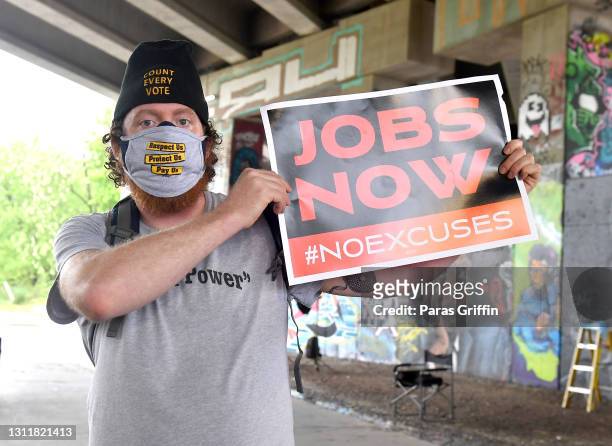 Supporter holds a sign at the Recovery Recess event to call for economic recovery and infrastructure package prioritizing climate, care, jobs, and...