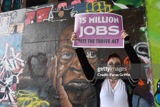 Supporter holds a sign at the Recovery Recess event to call for economic recovery and infrastructure package prioritizing climate, care, jobs, and...