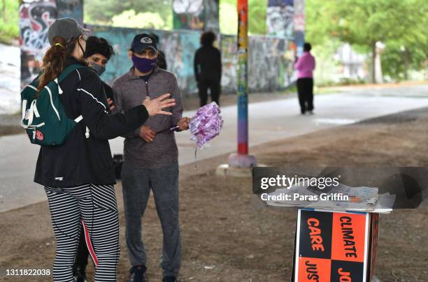 Event volunteer speaks to patrons during the Recovery Recess event to call for economic recovery and infrastructure package prioritizing climate,...