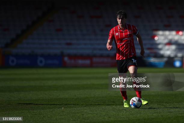 Joe Walsh of Lincoln City dribbles the ballduring the Sky Bet League One match between Lincoln City and Blackpool at Sincil Bank Stadium on April 10,...