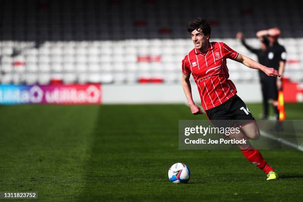 Joe Walsh of Lincoln City dribbles the ball during the Sky Bet League One match between Lincoln City and Blackpool at Sincil Bank Stadium on April...