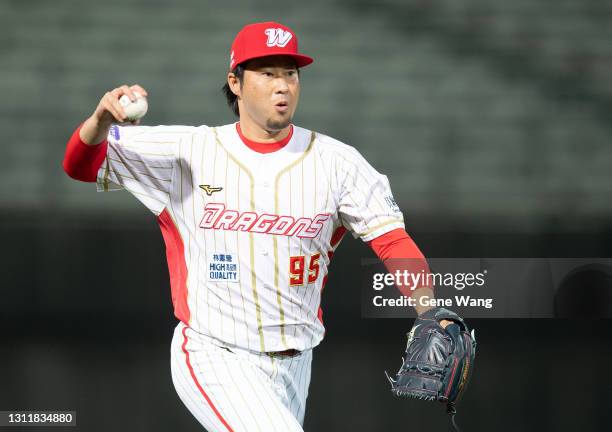 Pitcher Junichi Tazawa of Wei Chuan Dragons pass the ball at the top of the 10th inning during the CPBL game between Rakuten Monkeys and Wei Chuan...