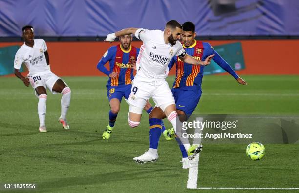 Karim Benzema of Real Madrid scores their side's first goal during the La Liga Santander match between Real Madrid and FC Barcelona at Estadio...
