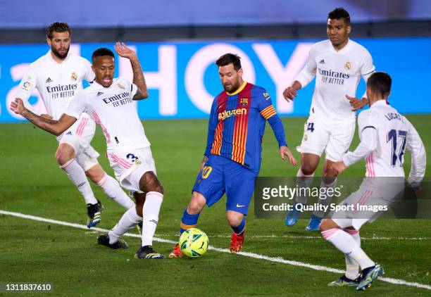Eder Militao of Real Madrid competes for the ball with Lionel Messi of FC Barcelona during the La Liga Santander match between Real Madrid and FC...