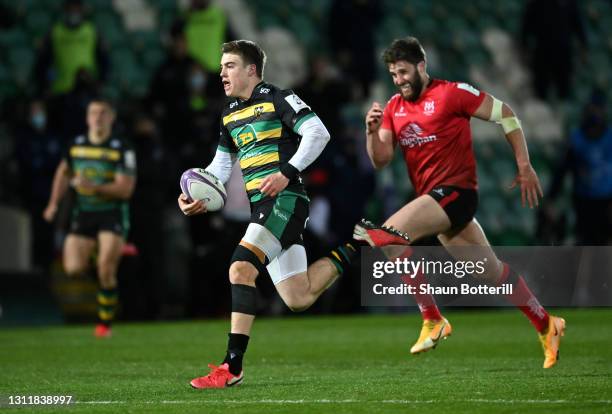Tommy Freeman of Northampton Saints breaks through to score their third try during the European Rugby Challenge Cup match between Northampton Saints...
