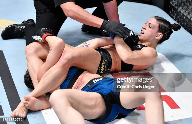 Mackenzie Dern secures an arm bar submission against Nina Nunes in a strawweight fight during the UFC Fight Night event at UFC APEX on April 10, 2021...