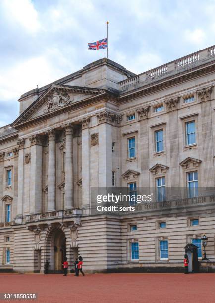 the union jack flag at buckingham palace is flying at half mast in london, uk - half mast stock pictures, royalty-free photos & images