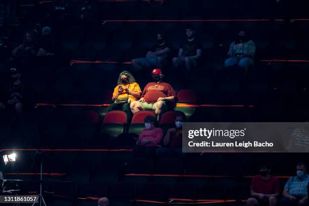 Fans sit social distanced in the stands before the start of the Cleveland Cavaliers home game against the Toronto Raptors at Rocket Mortgage...