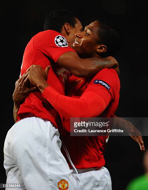 Antonio Valencia of Manchester United celebrates with Luis Nani as he scores their first goal during the UEFA Champions League Group C match between...