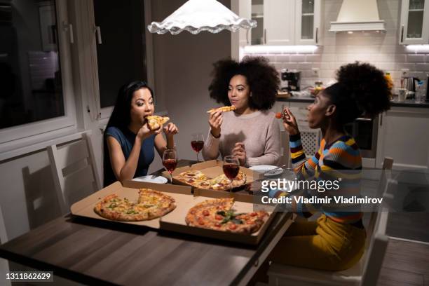 three young beautiful multi-ethnic women having fun at home party - wine home delivery stock pictures, royalty-free photos & images