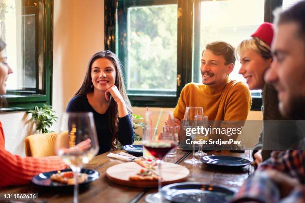happy young friends enjoying their time together during a lunch  in a restaurant - gastro pub stock pictures, royalty-free photos & images